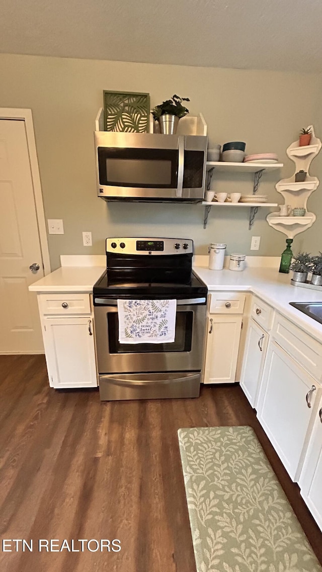 kitchen featuring open shelves, light countertops, stainless steel appliances, white cabinetry, and dark wood-style flooring