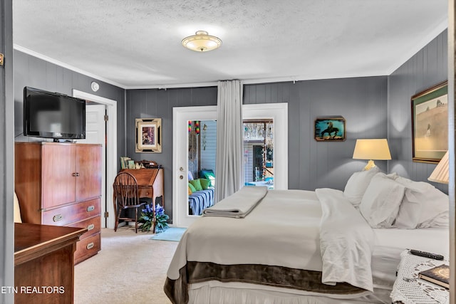 carpeted bedroom featuring a textured ceiling and ornamental molding