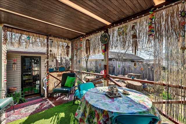 view of patio / terrace with a deck and fence