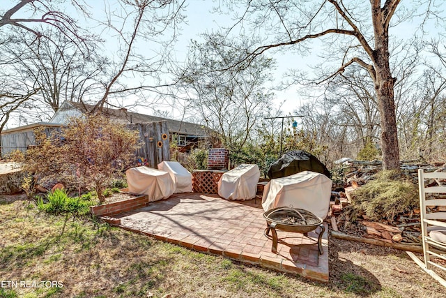 view of yard featuring a patio and an outdoor fire pit