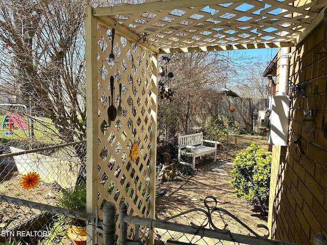 exterior space featuring a pergola and fence