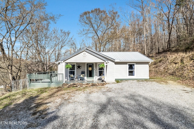 view of front of property featuring covered porch and metal roof