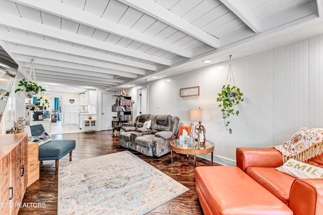 living area with dark wood finished floors and beam ceiling