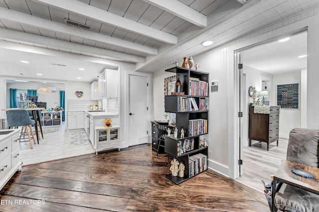 interior space featuring recessed lighting, visible vents, beamed ceiling, and wood finished floors