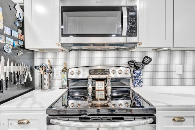 kitchen featuring white cabinets, backsplash, and appliances with stainless steel finishes