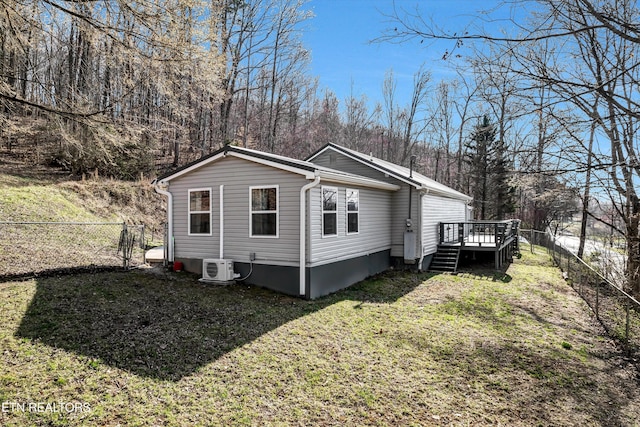 view of side of home featuring ac unit, a yard, a deck, and a fenced backyard