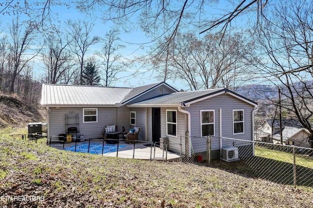 back of house with a patio, a yard, fence, and metal roof