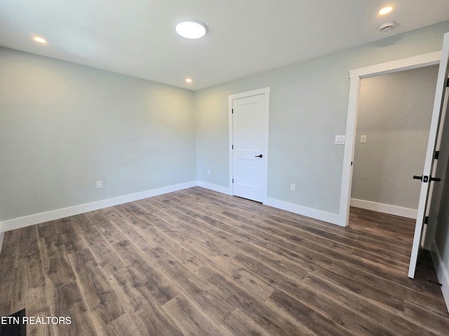 unfurnished bedroom featuring dark wood finished floors, recessed lighting, and baseboards