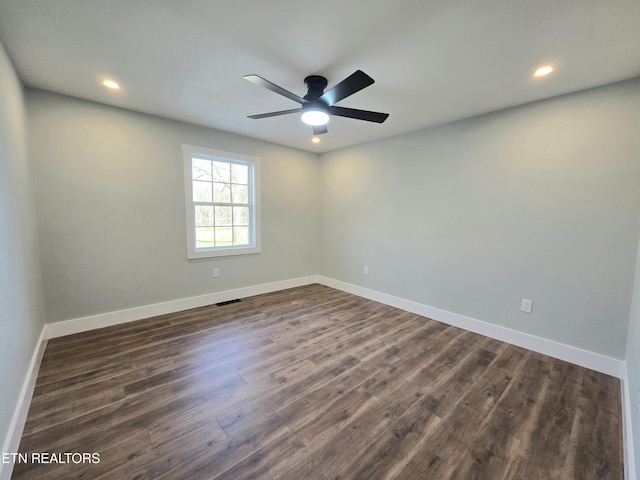 unfurnished room featuring dark wood-style floors, visible vents, recessed lighting, and baseboards