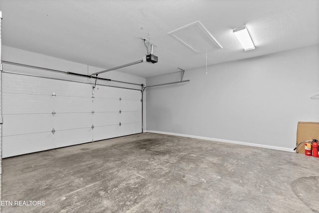 garage with baseboards and a garage door opener