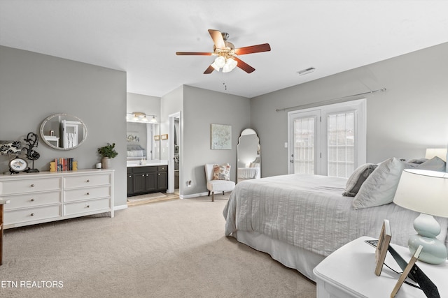 bedroom with access to exterior, connected bathroom, baseboards, ceiling fan, and light carpet