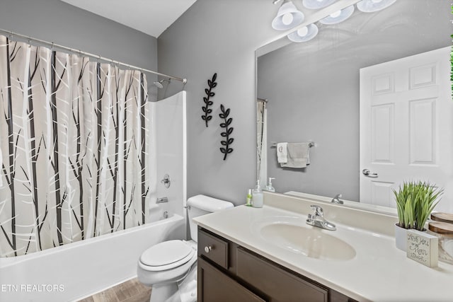 bathroom featuring vanity, shower / tub combo, and toilet