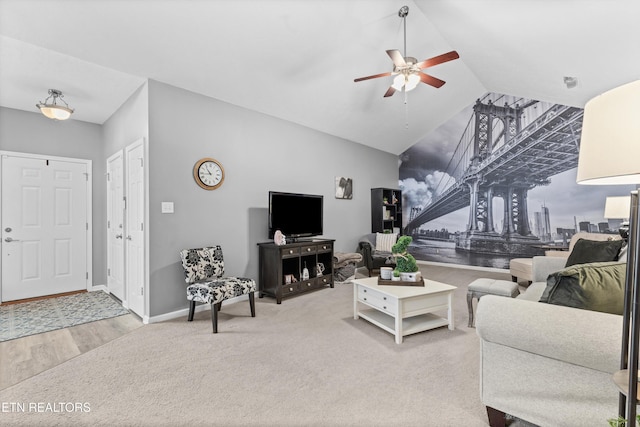 living area with baseboards, lofted ceiling, carpet, and ceiling fan