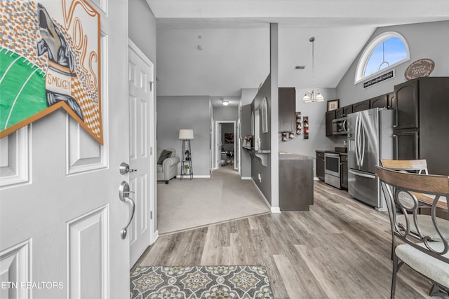 foyer with baseboards, visible vents, high vaulted ceiling, an inviting chandelier, and light wood-style floors