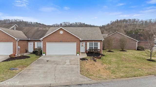 single story home featuring brick siding, driveway, a front yard, and an attached garage