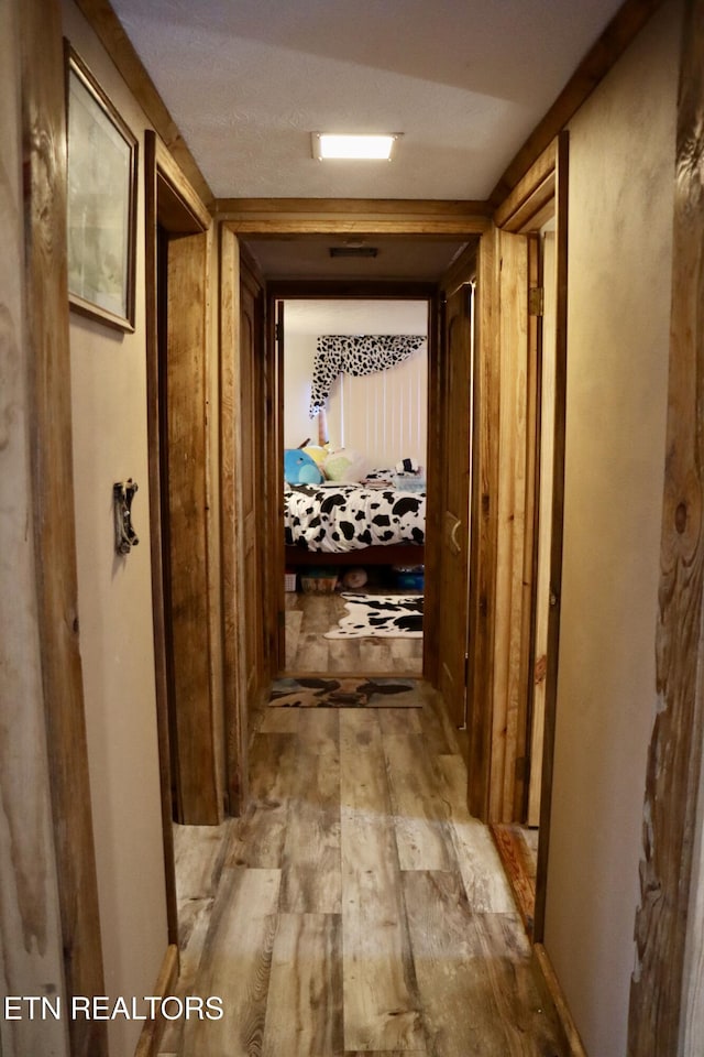 hallway with wood finished floors