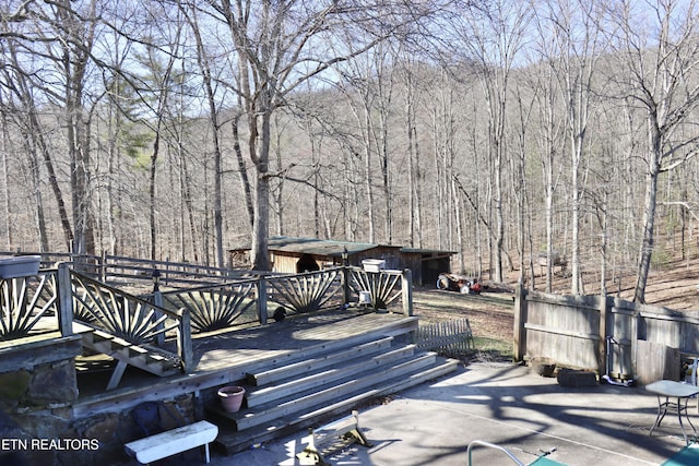 wooden deck featuring a forest view