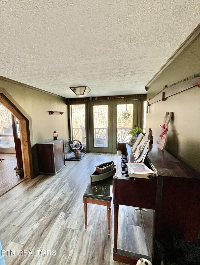 interior space featuring a textured ceiling and wood finished floors