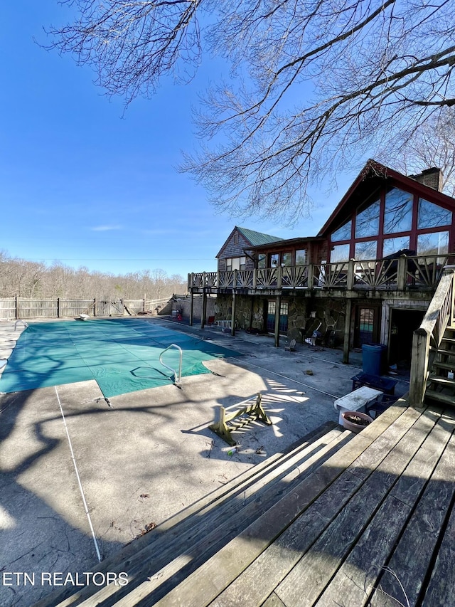 view of pool featuring a deck, a patio, fence, a fenced in pool, and stairs