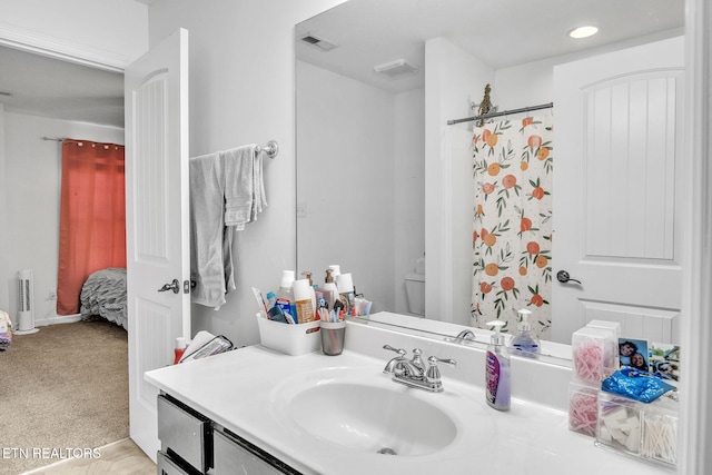 bathroom featuring vanity, toilet, recessed lighting, and visible vents