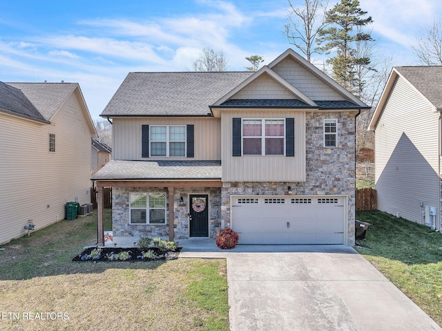 craftsman-style home with a front yard, stone siding, driveway, and a shingled roof