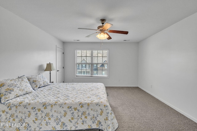 carpeted bedroom featuring visible vents, ceiling fan, a textured ceiling, and baseboards