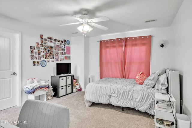 bedroom featuring a ceiling fan, visible vents, and carpet floors