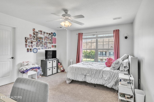 carpeted bedroom featuring visible vents and ceiling fan