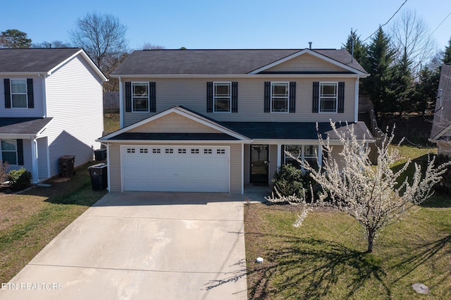 traditional home featuring a garage, a front yard, and driveway