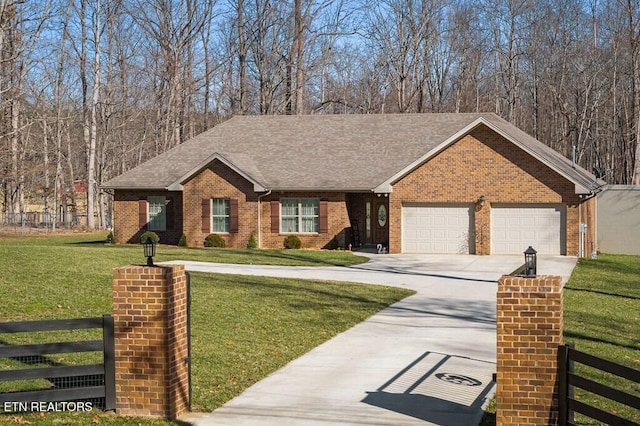 ranch-style home with brick siding, concrete driveway, a front yard, and fence