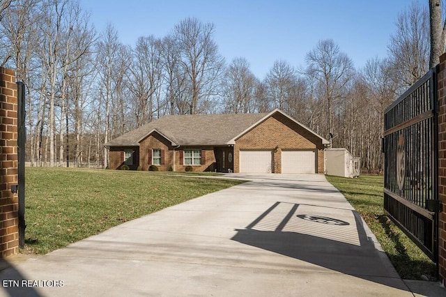 view of front of house with brick siding, driveway, an attached garage, and a front yard