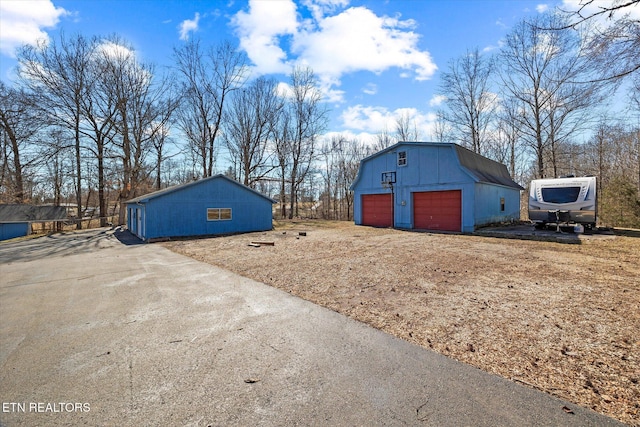 exterior space featuring an outbuilding and a garage