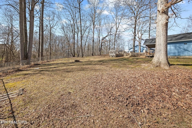 view of yard featuring fence and a wooden deck