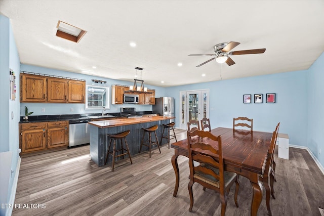 dining area featuring light wood-style flooring, recessed lighting, and baseboards