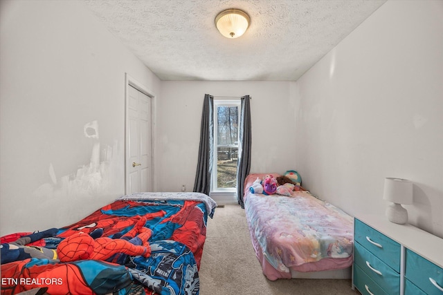 carpeted bedroom with a textured ceiling