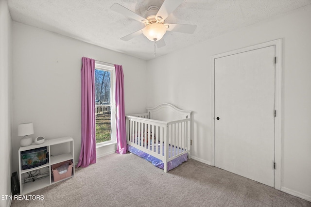 bedroom with multiple windows, a textured ceiling, and carpet flooring