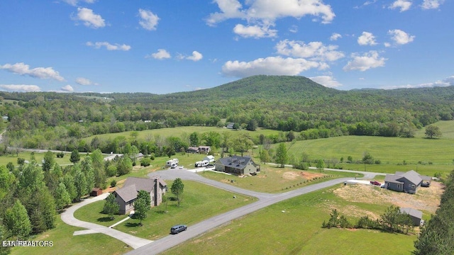 drone / aerial view featuring a rural view, a mountain view, and a forest view