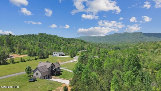 drone / aerial view with a forest view and a mountain view