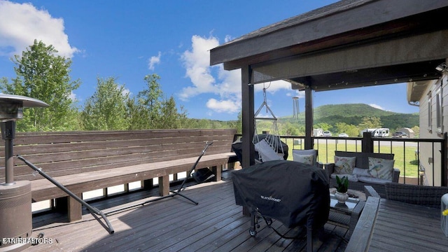 deck featuring a mountain view and a grill