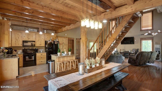 dining space with beamed ceiling, light wood-style floors, wooden ceiling, and stairs