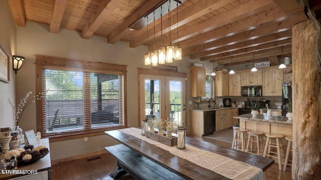 dining area with light wood-style floors, beamed ceiling, wood ceiling, and visible vents