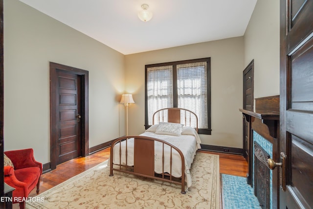 bedroom featuring baseboards and wood finished floors