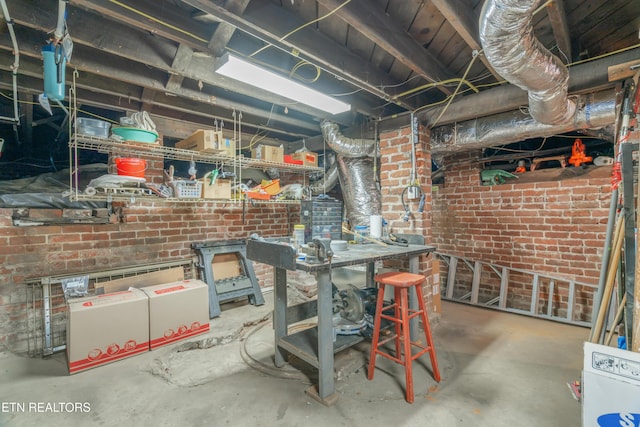 unfinished basement featuring brick wall