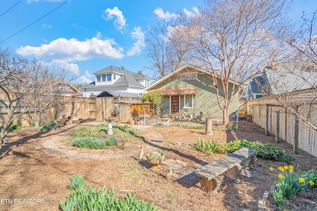 rear view of property with a fenced backyard