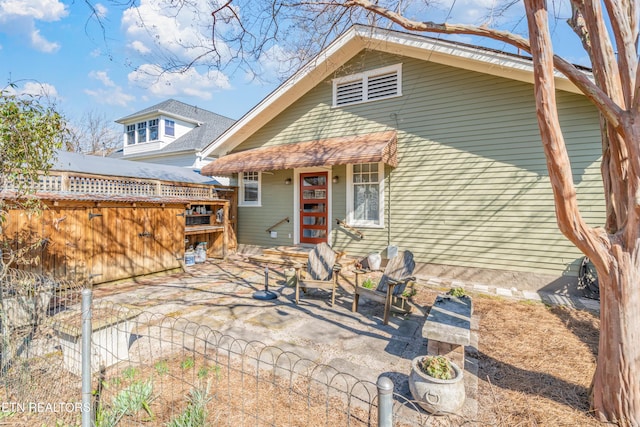 back of house with a patio area and fence