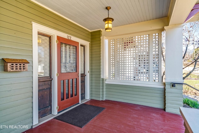 view of exterior entry with a porch