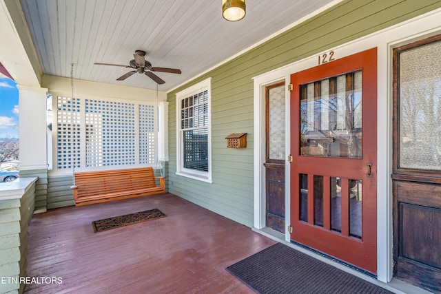 property entrance with a ceiling fan and covered porch