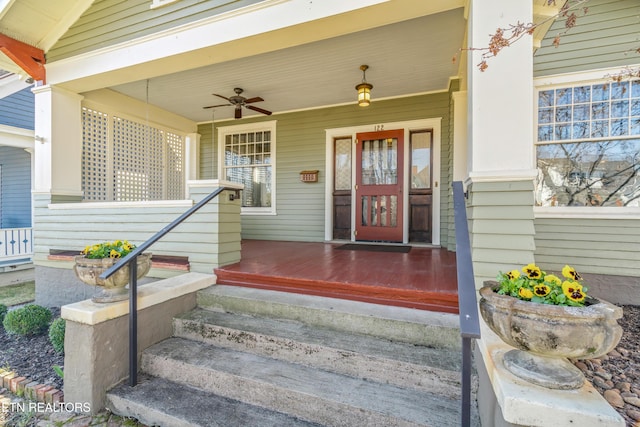 view of exterior entry featuring a porch and ceiling fan