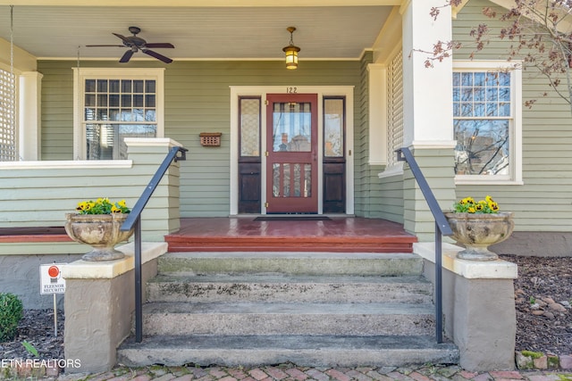 view of exterior entry with a porch and a ceiling fan