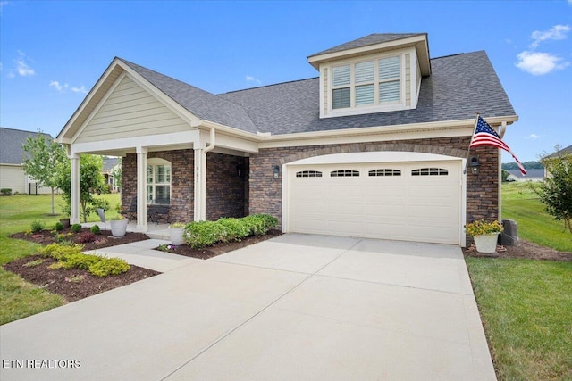 view of front facade with a front lawn, covered porch, concrete driveway, an attached garage, and a shingled roof